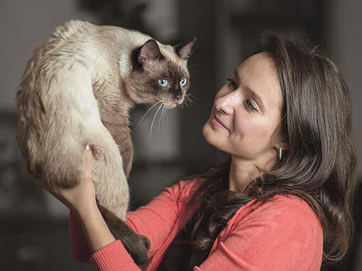 Woman holding up Cat