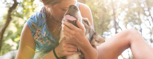 Woman cuddling her dog